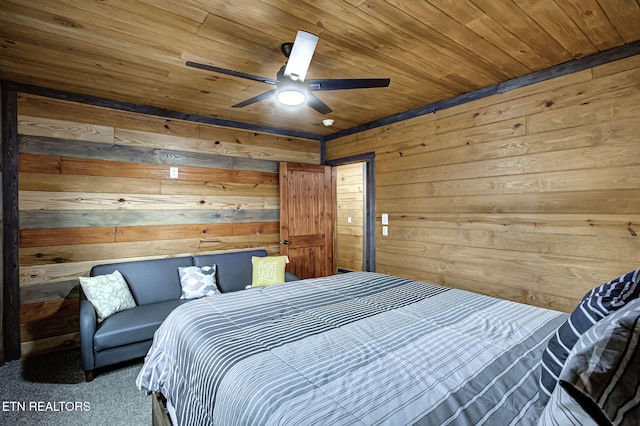 carpeted bedroom featuring ceiling fan, wooden walls, and wood ceiling