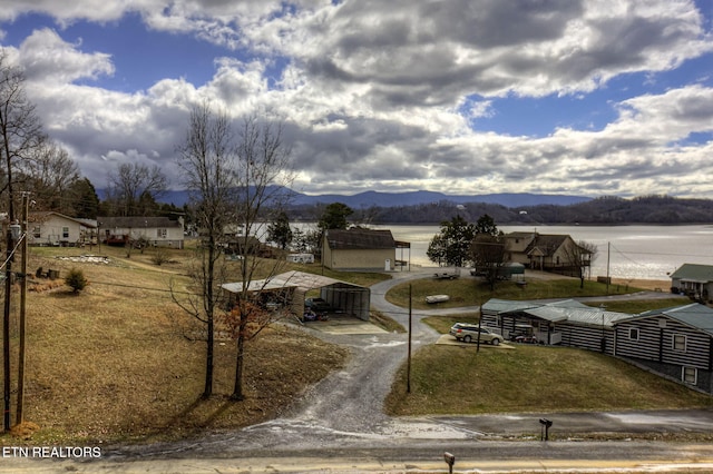 exterior space featuring a carport and a water and mountain view