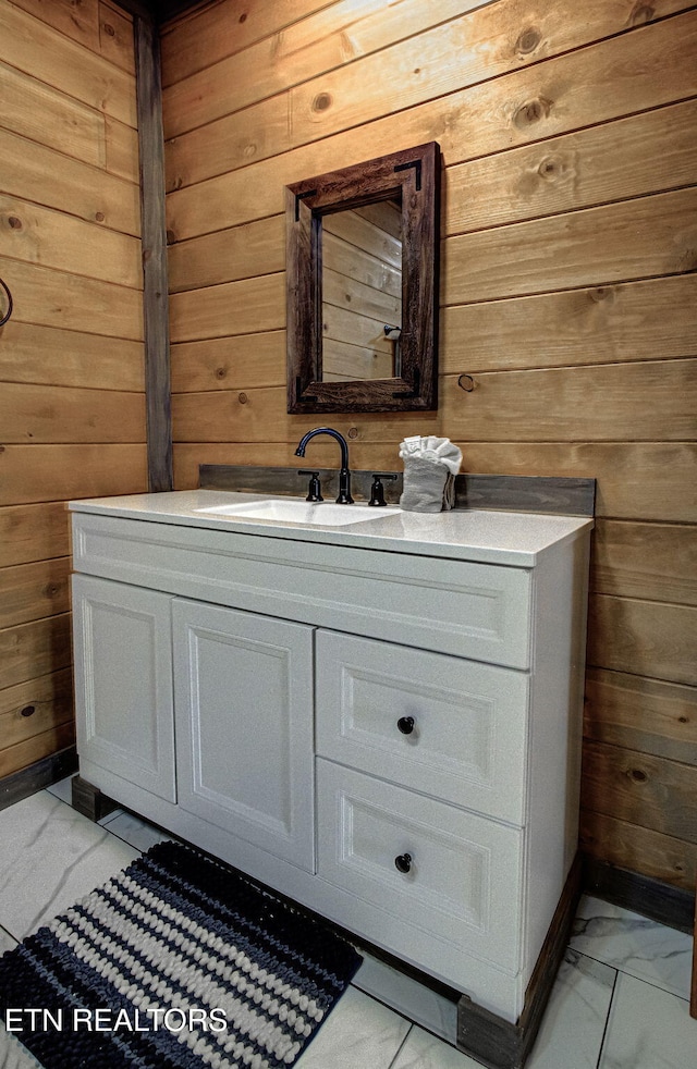 bathroom featuring vanity and wooden walls