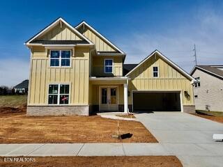 craftsman inspired home featuring board and batten siding, french doors, concrete driveway, and a garage