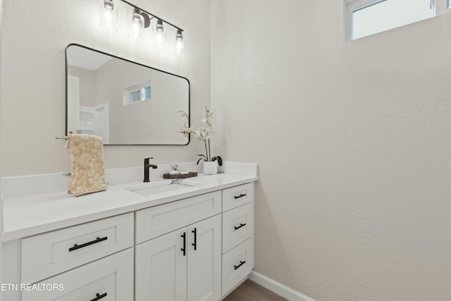 bathroom featuring vanity and baseboards