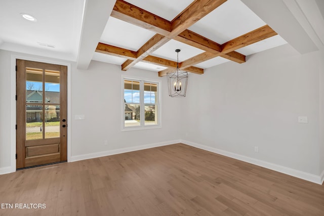 interior space with baseboards, a chandelier, beamed ceiling, wood finished floors, and coffered ceiling