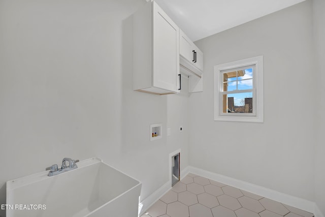 laundry area with baseboards, hookup for a washing machine, cabinet space, hookup for an electric dryer, and a sink