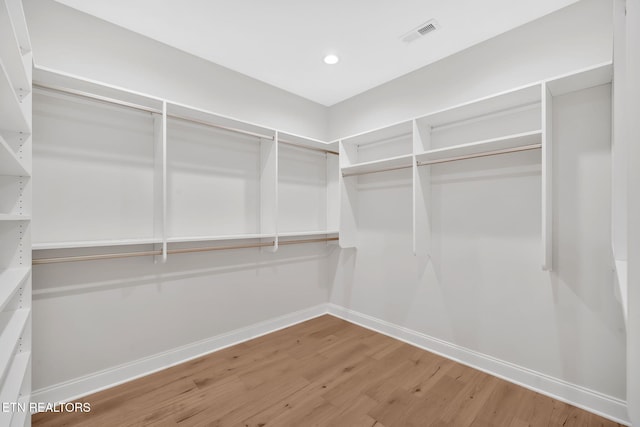 walk in closet featuring visible vents and wood finished floors