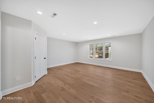 empty room with recessed lighting, baseboards, visible vents, and light wood-type flooring