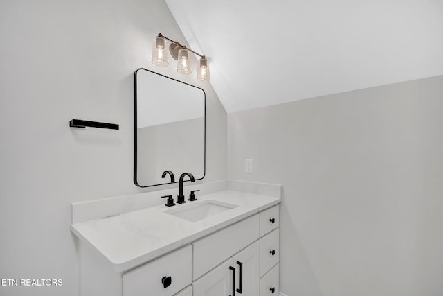 bathroom with vanity and vaulted ceiling