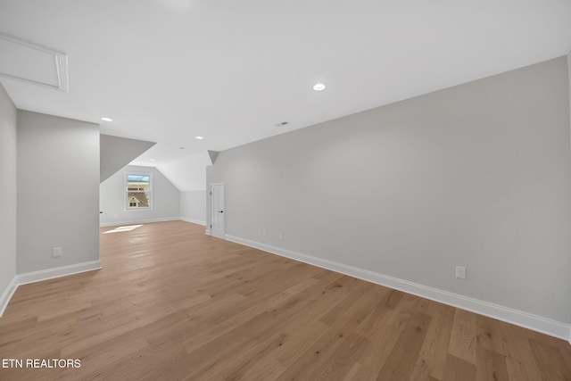 bonus room with vaulted ceiling, recessed lighting, baseboards, and light wood-type flooring