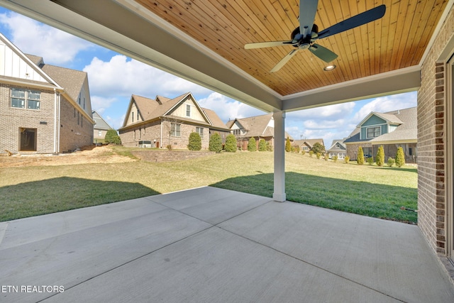 view of patio with a residential view and ceiling fan