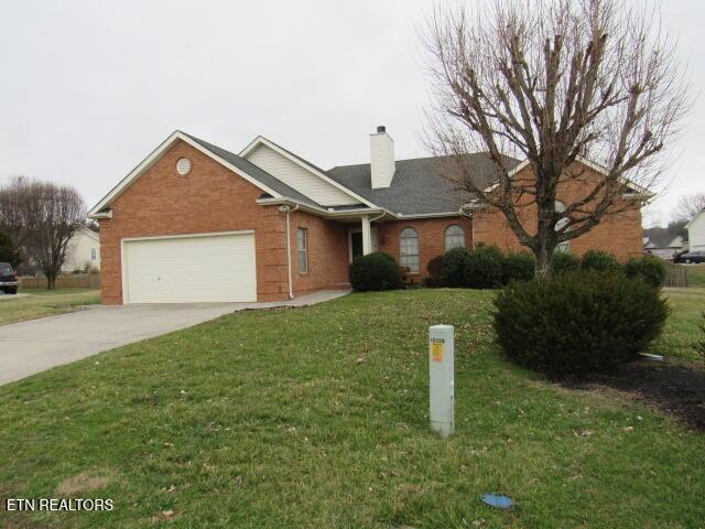 single story home featuring a garage, a front yard, brick siding, and driveway