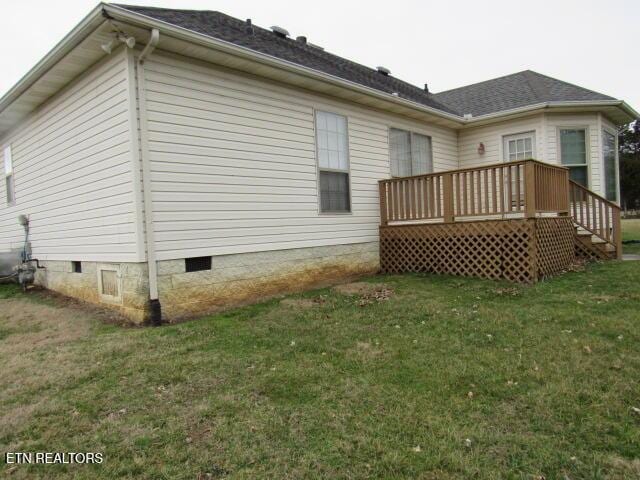 back of property featuring crawl space, a lawn, and a wooden deck