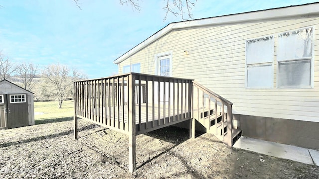 view of home's exterior featuring a wooden deck and a storage unit