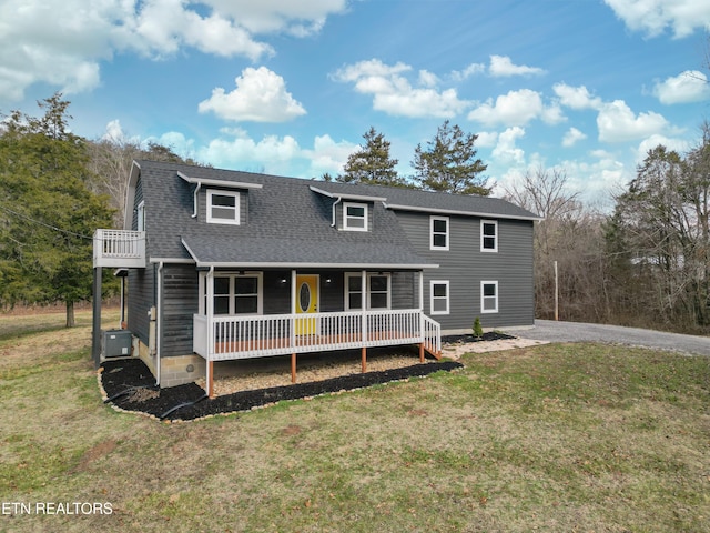 rear view of property featuring a porch, a yard, and central air condition unit