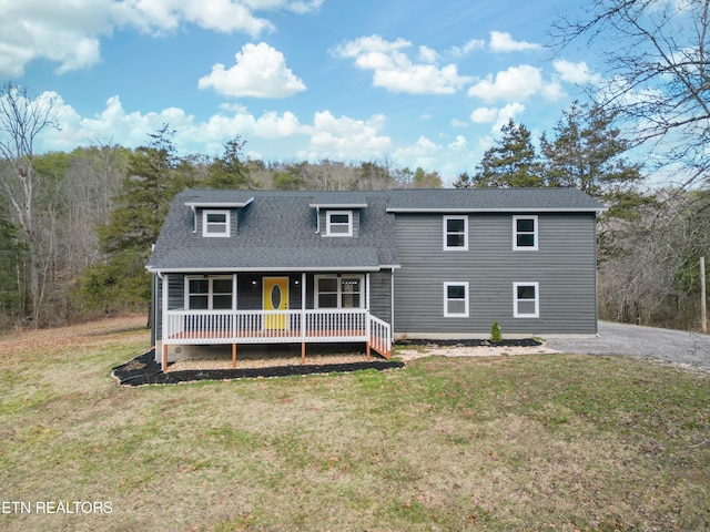 back of house with a yard and covered porch