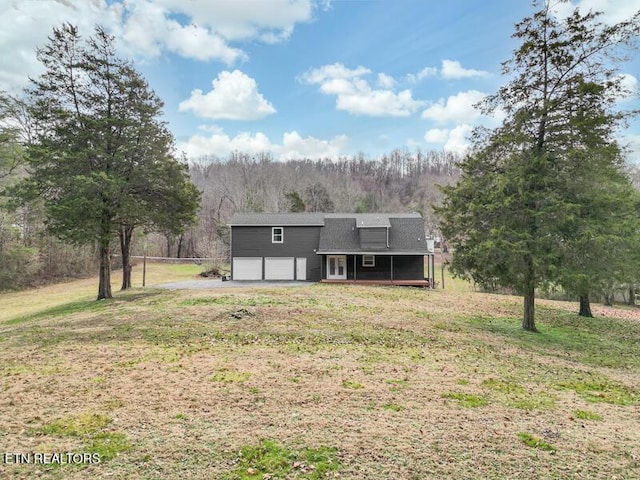 view of front of property with a garage and a front lawn