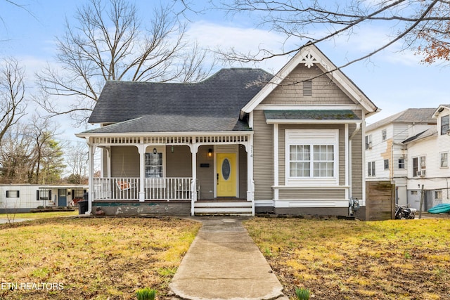 view of front of house featuring covered porch and a front yard