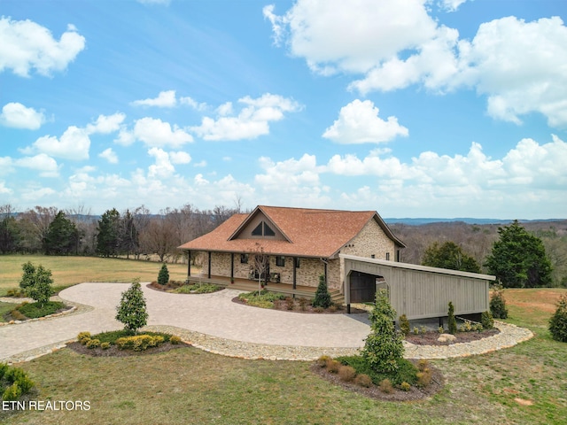 view of front of house featuring decorative driveway and a front yard