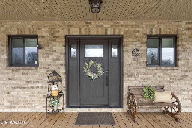 view of exterior entry with brick siding