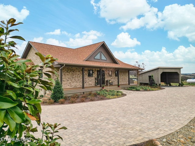 view of front of home featuring covered porch and brick siding