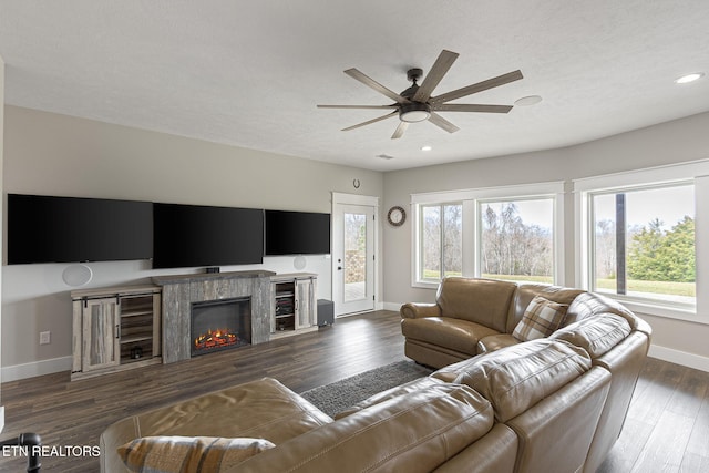 living room with ceiling fan, plenty of natural light, baseboards, and dark wood finished floors