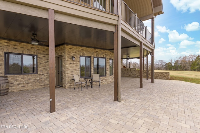 view of patio / terrace featuring outdoor dining space, ceiling fan, and a balcony