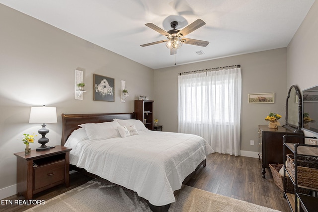 bedroom featuring a ceiling fan, baseboards, visible vents, and dark wood-style flooring