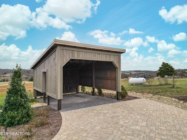 view of outdoor structure with a garage and decorative driveway