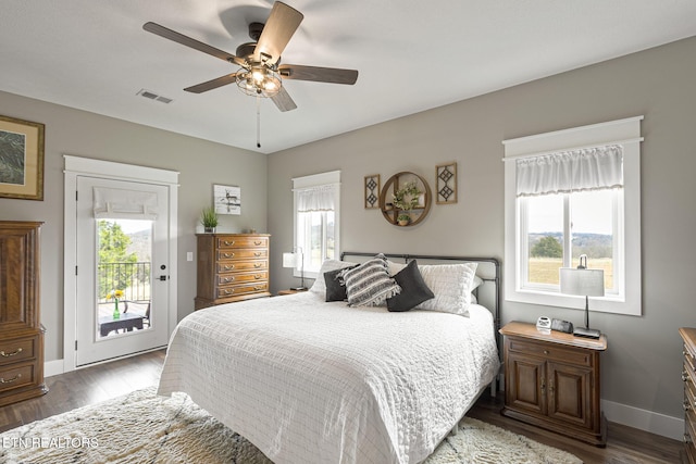 bedroom featuring access to outside, dark wood-type flooring, visible vents, and baseboards