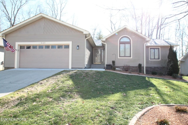 ranch-style house featuring a garage, driveway, and a front yard