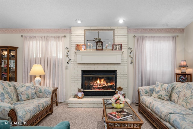 living room with carpet, a fireplace, and a textured ceiling