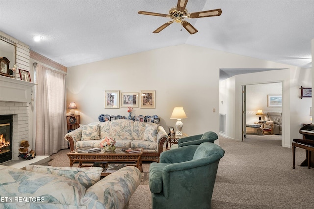 living area with visible vents, light colored carpet, lofted ceiling, a textured ceiling, and a brick fireplace