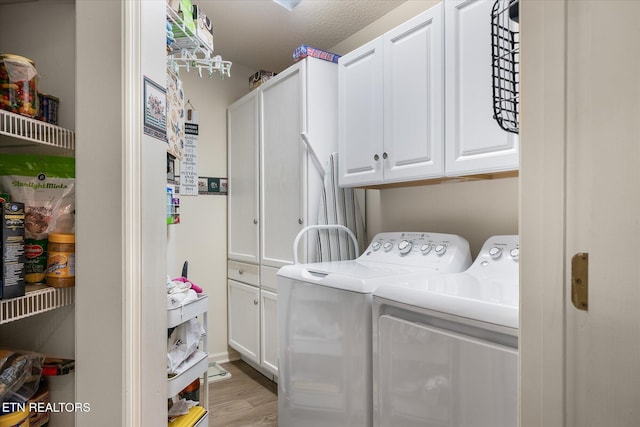 laundry room with light wood-type flooring, cabinet space, and independent washer and dryer