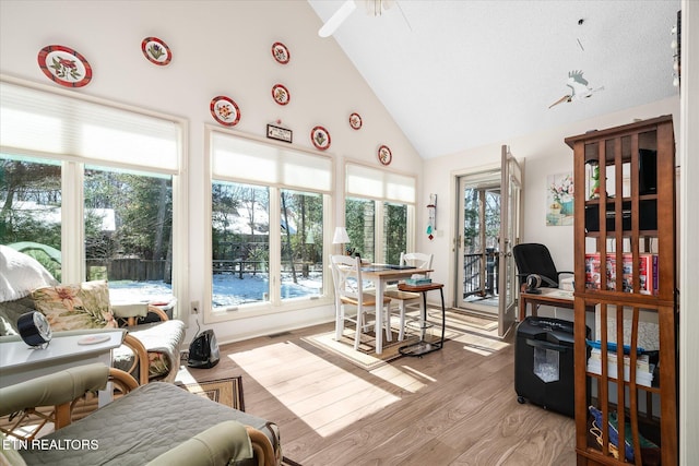 sunroom / solarium with lofted ceiling, visible vents, and a ceiling fan