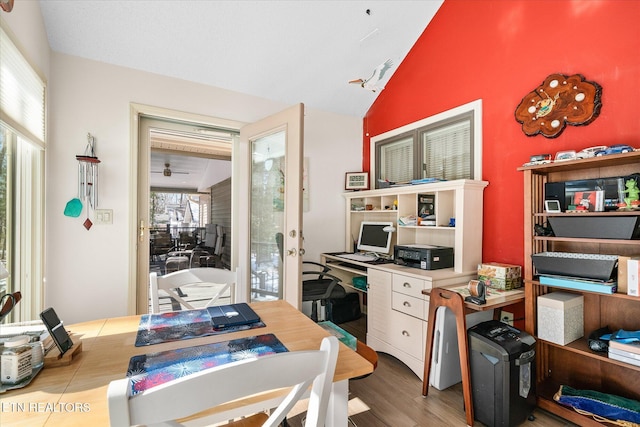 home office with vaulted ceiling and wood finished floors