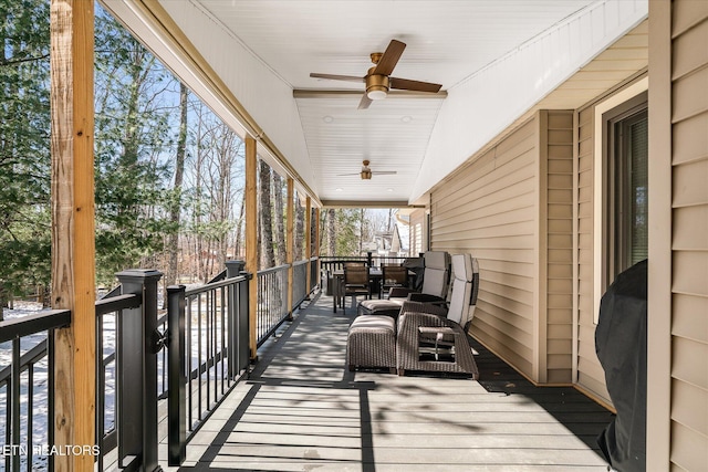 wooden deck with ceiling fan and outdoor dining area