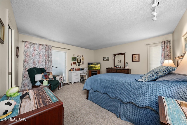 carpeted bedroom with a textured ceiling