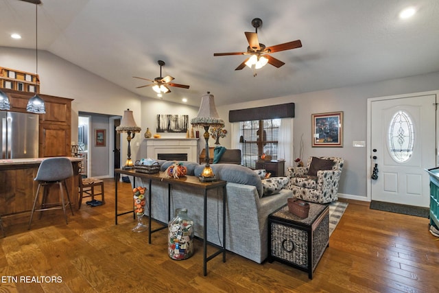 living room with vaulted ceiling, ceiling fan, and dark hardwood / wood-style flooring