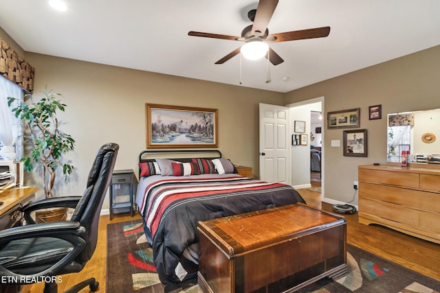 bedroom with dark wood-type flooring and ceiling fan