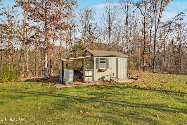 view of outdoor structure featuring a lawn