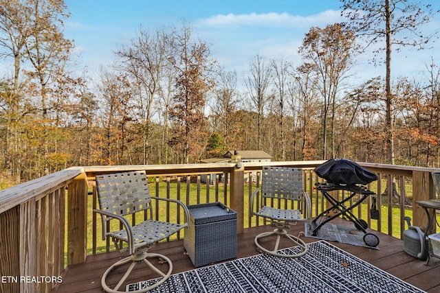 wooden deck featuring a lawn