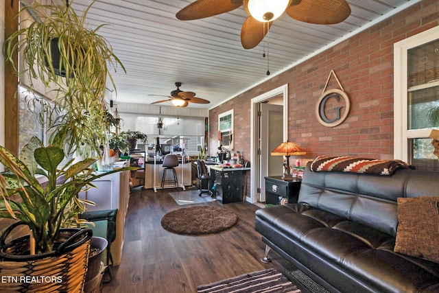 interior space with brick wall and dark hardwood / wood-style flooring