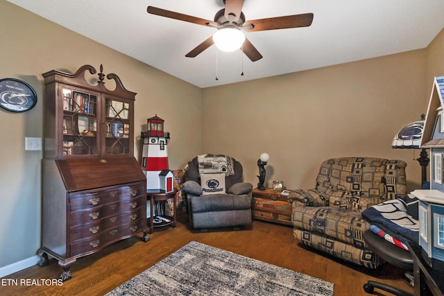 sitting room with wood-type flooring and ceiling fan