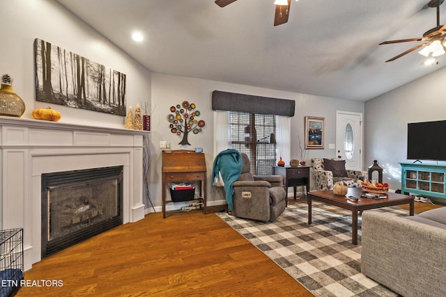 living room featuring lofted ceiling, ceiling fan, and light hardwood / wood-style flooring