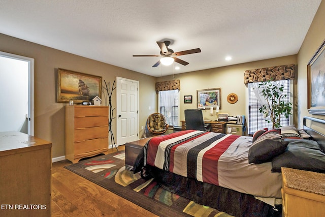 bedroom with dark wood-type flooring and ceiling fan