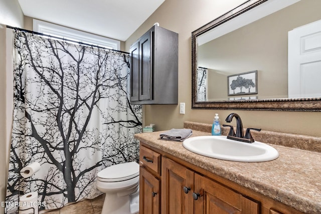 bathroom with vanity, tile patterned floors, and toilet