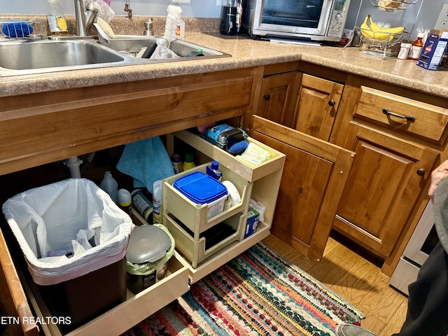 interior details featuring sink and hardwood / wood-style flooring