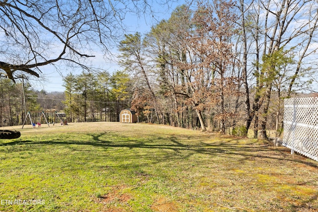 view of yard with a shed and a playground