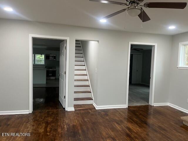 interior space with ceiling fan and dark hardwood / wood-style flooring