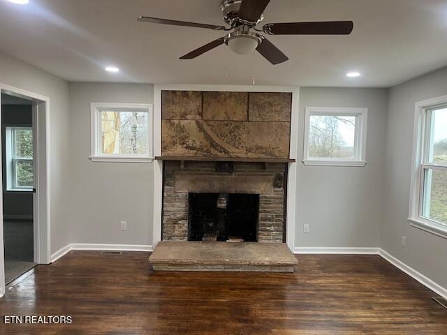 unfurnished living room with ceiling fan, a fireplace, and dark hardwood / wood-style flooring