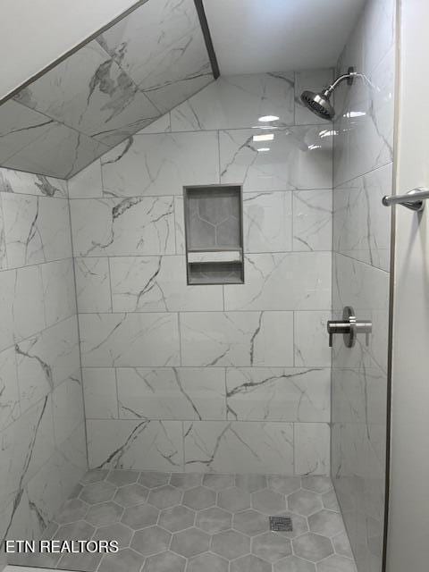 bathroom with a tile shower