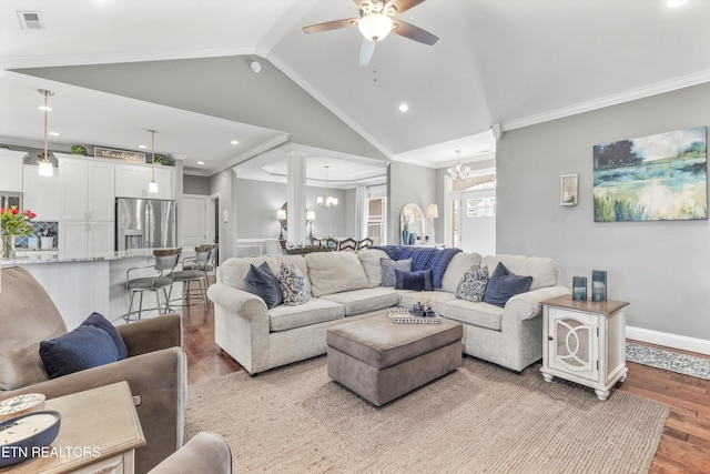 living room with light hardwood / wood-style floors, crown molding, and lofted ceiling